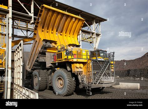 large dump truck dumping copper ore  giant crusher stock photo alamy