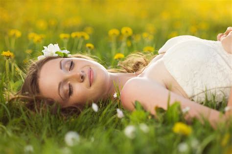 Beautiful Girl Is Relaxing Lying On The Grass In The Garden Royalty