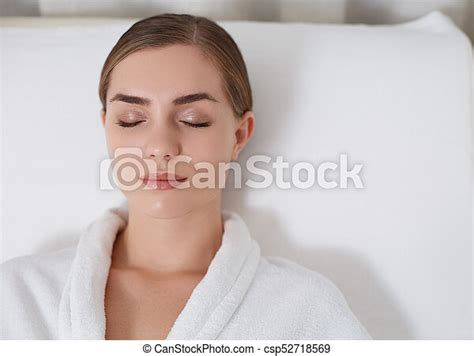 Tranquil Young Woman Lying On Daybed At Spa Lounge Top View Of