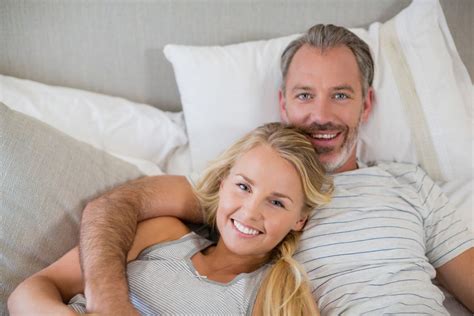 Happy Couple Relaxing On Bed In Bedroom Photo From Pikwizard