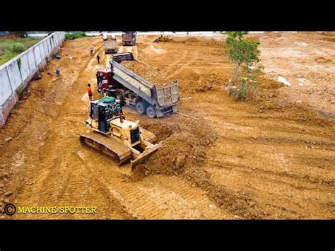 drivering drone  flying    bulldozer pushing land dump truck unloading