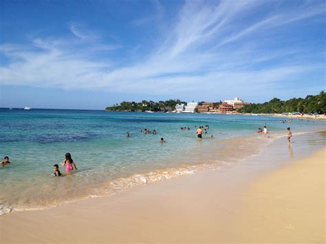 Many People Are On The Beach And In The Water At This Point There Is