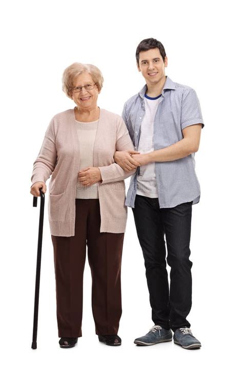 elderly lady walking cane young man helping  stock