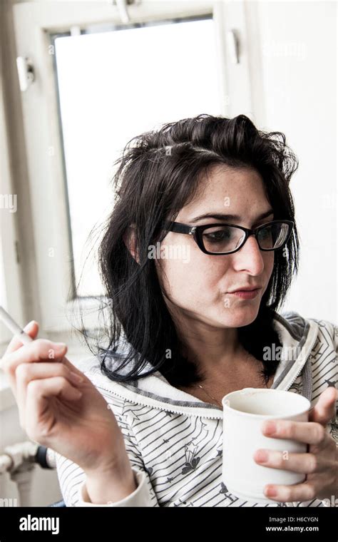 A Woman Drinking Her Morning Coffe And Smoking Her Morning Cigarette