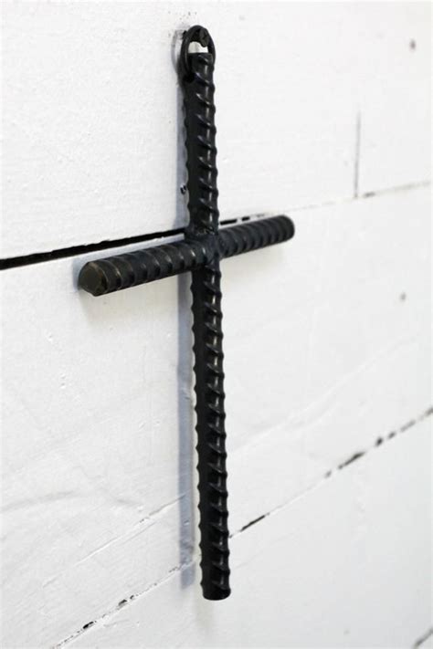 iron cross hanging   side   white wall  screws attached
