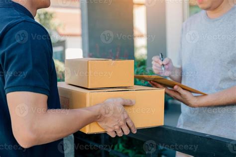 delivery young man standing   door  home  carrying parcels