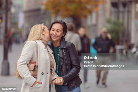 Attractive And Modern Lesbians Are Walking In The Streets And Embracing