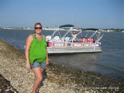 wife posing with the boat picture of captain barry s backbay cruises