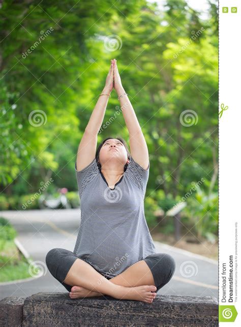 pregnant woman exercise and yoga in the park stock image