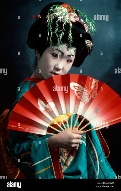 japanese kabuki dancer  geisha costume holding red fan stock photo