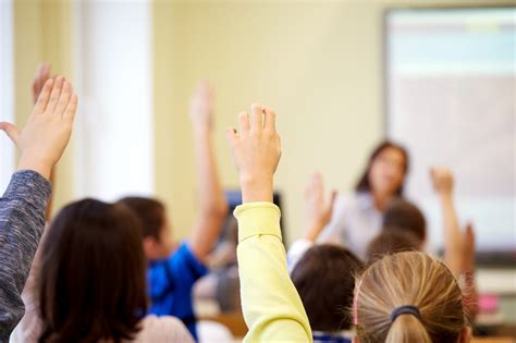 group  school kids raising hands  classroom national association