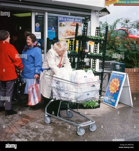 elderly woman   full shopping trolley    op stock photo royalty  image
