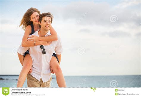 Romantic Happy Couple On The Beach At Sunset Royalty Free