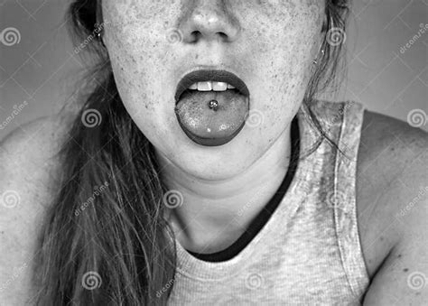 Close Up Portrait Of Young Woman Sticking Out Pierced Tongue Showing
