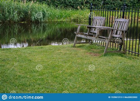 wooden chairs   backyard  pond  outdoor