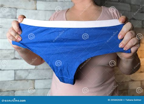 Woman Holding Blue Female Panties In Her Hands Knitted Underwear