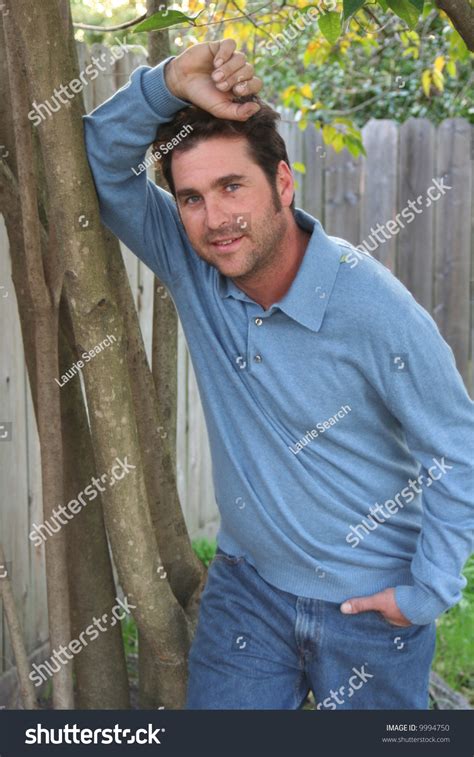 man leaning   tree stock photo  shutterstock