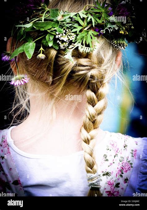 Girl With Braids And Flowers In Her Hair Celebrating Midsummer In