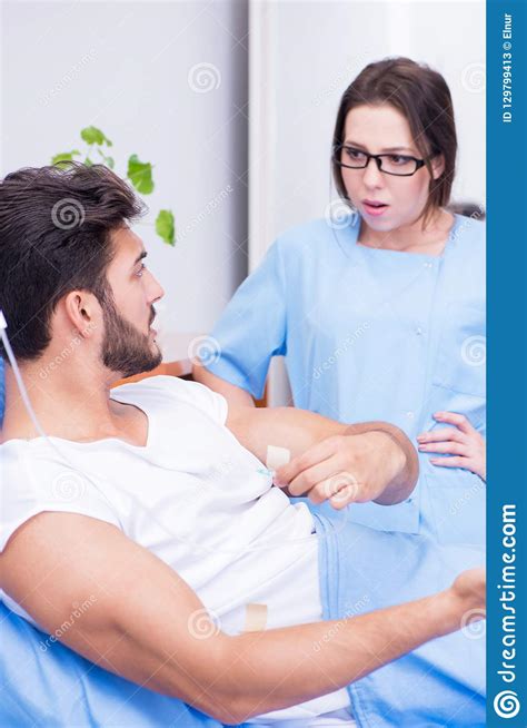 The Woman Doctor Examining Male Patient In Hospital Stock Image Image