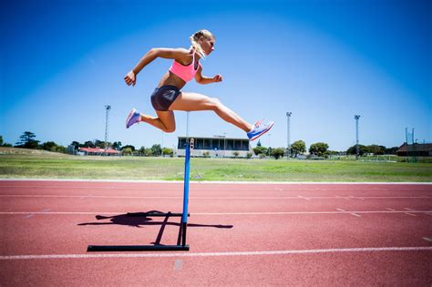 female athlete jumping   hurdle computer business review