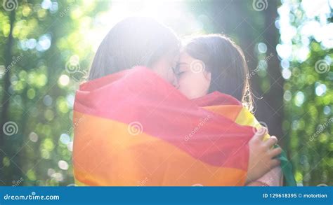 Lesbian Lovers Wrapped In Rainbow Flag Kissing Tenderness And Love