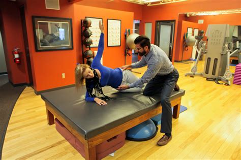 chiropractor helps woman stretch hips goodyear chiropractic health center