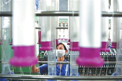 a worker operates a machine at a textile company in baoji shaanxi province xinhua