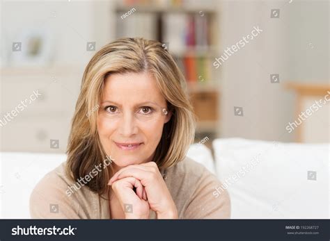 beautiful friendly middleaged woman sitting looking stock
