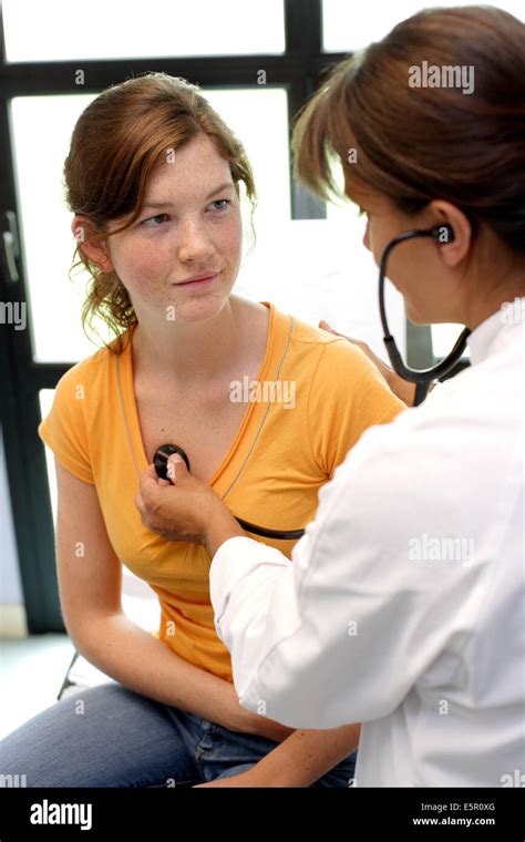 Doctor Examining Chest Of A Female Teenager With A Stethoscope Stock