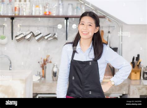 Portrait Of Beautiful Young Barista Asian Woman Is A Employee Standing