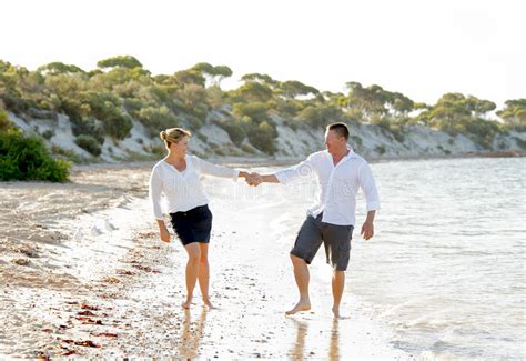 attractive beautiful couple in love walking on the beach in romantic summer holidays stock image