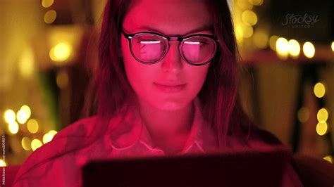 woman with glasses looking at the monitor by stocksy contributor