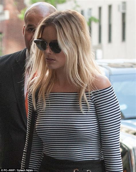 margot robbie goes braless in black and white off shoulder