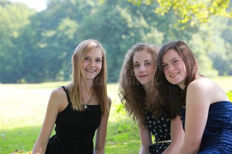 Three Teenage Girls Helping Their Friend To Get Dressed Hoodoo Wallpaper