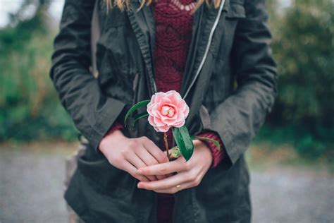 woman holding flower willow health  aesthetics
