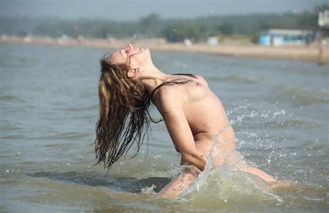 smiling teen plays with water at sea russian sexy girls