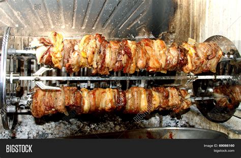 spit roast meat cooked fireplace image and photo bigstock