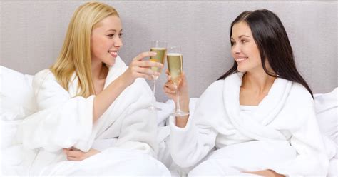Happy Women Or Girlfriends Clinking Champagne Glasses In Bed Ohspa