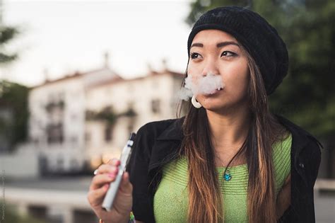 Asian Woman Smoking With E Cigarette By Mauro Grigollo