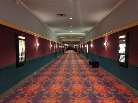 uncomfortably long wide  empty  theater hallway  doors