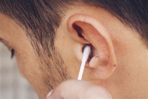 man   clean  ears   tip cotton swab hygiene essentials