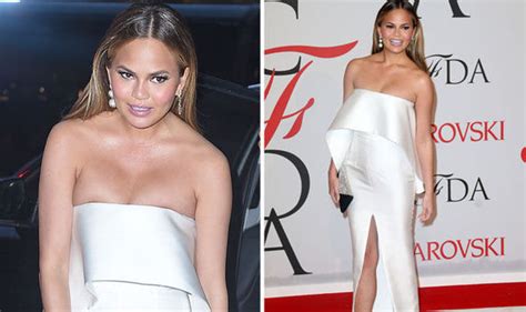 chrissy teigen struggles to contain her assets in strapless thigh split