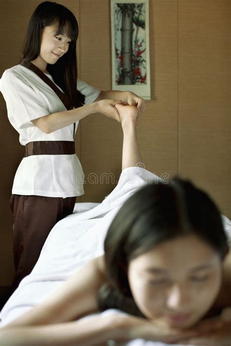 Mother And Daughter Having Back Massage Together Stock