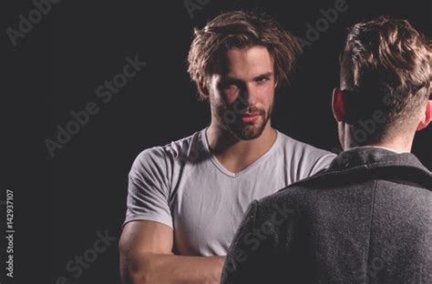 Two Handsome Men Standing With Faces Opposite Photo Stock Adobe Stock