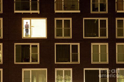 solitary businessman    apartment window  night photograph  conceptual images