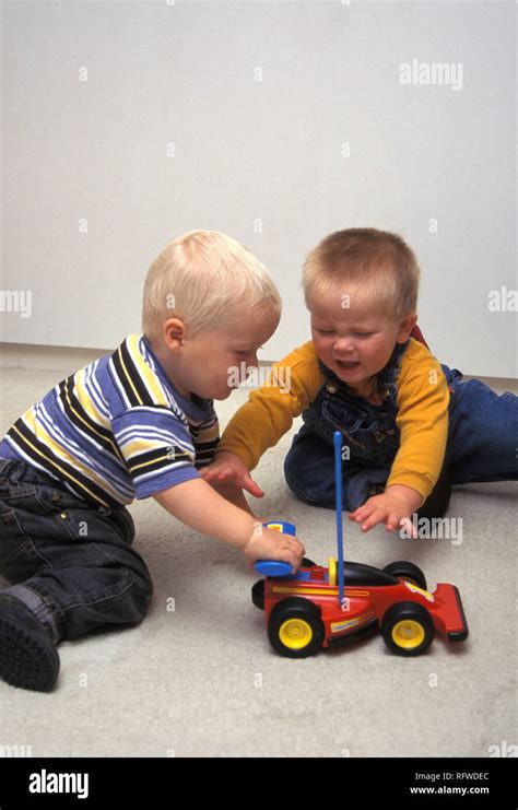 boys fighting  toy car stock photo alamy