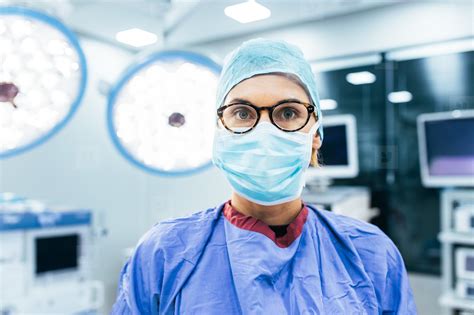 female surgeon wearing surgical mask  scrubs stock photo