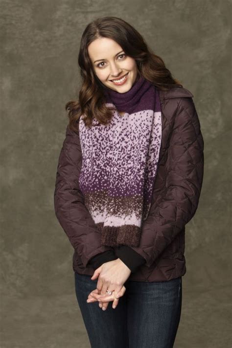 smiling woman wearing  purple  black sweater   animal print