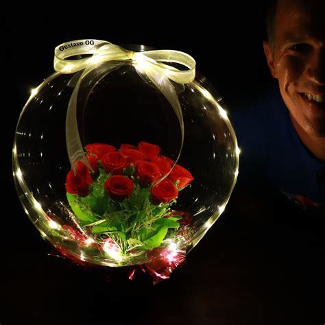 man  smiling    glass bowl  flowers    lights