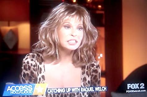 raquel welch 76 cuts very youthful figure in racy slashed jumper and curve hugging jeans